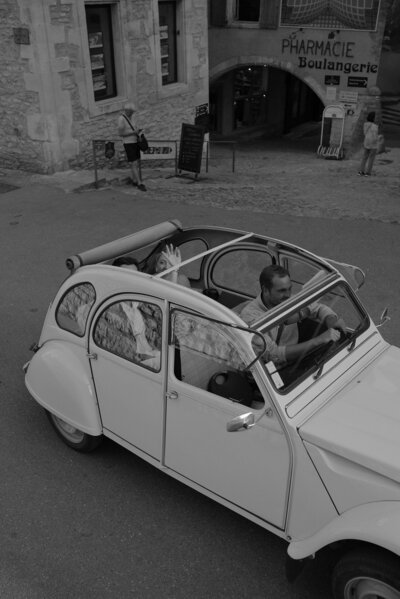 Vintage Citroen 2cV driving through  the small French village of Gordes for a wedding