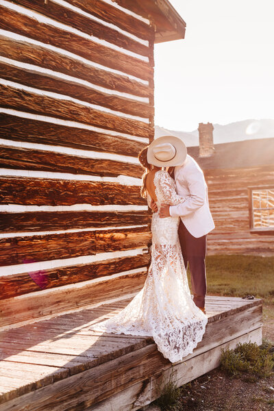 bride and groom  kissing in the sunrise at their sunrise ghost town wedding