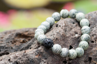 A Moss Agate Bracelet with Lava Rock with it.