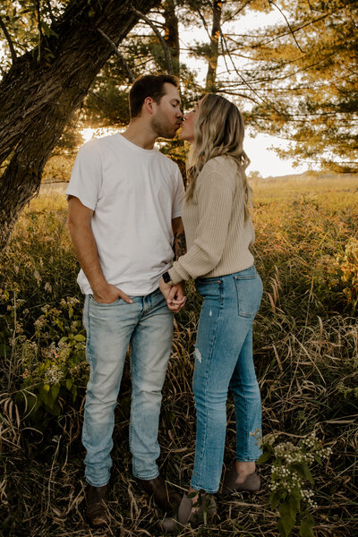 Romantic Omaha engagement session during the fall, captured by Tori Nichole Photography. The couple is surrounded by vibrant autumn foliage and golden light, creating warm, timeless moments. A perfect blend of natural beauty and authentic connection, showcasing the magic of the season and their love story.
