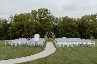 wedding ceremony in Wisconsin with greenery arch