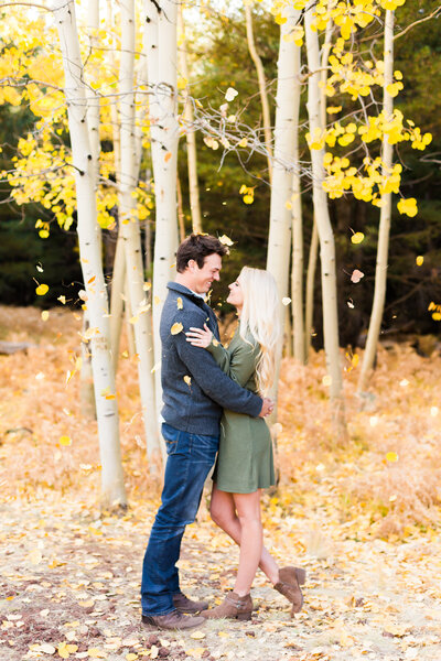 engagement photo of couple holding other in fall in Flagstaff