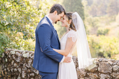 a bride and groom rest their foreheads together and embrace at their Sacramento wedding.