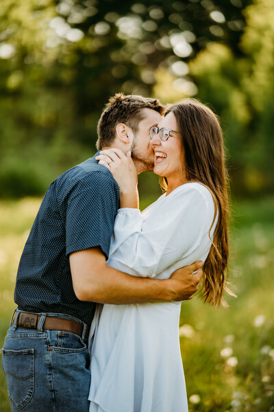 A couple whispering sweet nothings, capturing the intimate and personal connection that defines their love, set in Vermont's scenic backdrop.