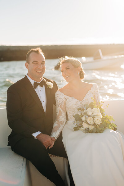 bride and groom take a boat ride