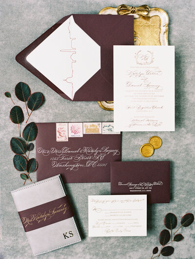 Burgundy, white and gold foil letterpress invitation suite featuring the DC skyline envelope liner and traditional Spencerian handwritten script