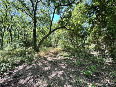 Aerial view of 11-acre property in Lindsay, Texas with open fields and clear skies