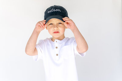 A toddler wearing a custom name hat