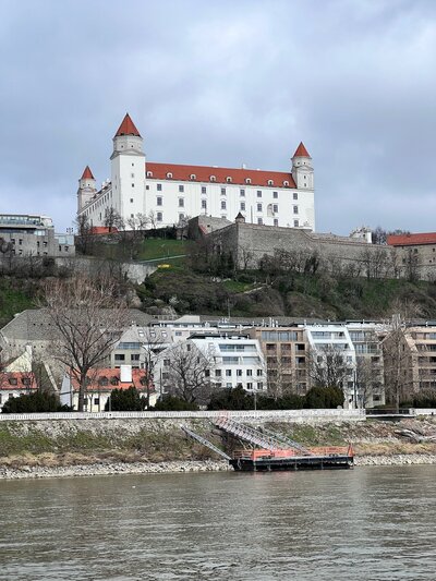 Photo of European Building on a Hill Above City Buildings
