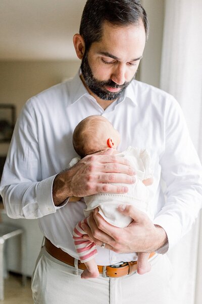 Indianapolis newborn photo of Father holding his baby girl by Katelyn Ng Photography.