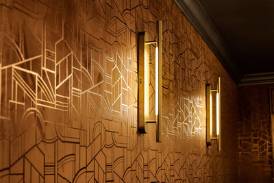 Geometric patterned wall with integrated lighting showcasing luxury hospitality interior design process.