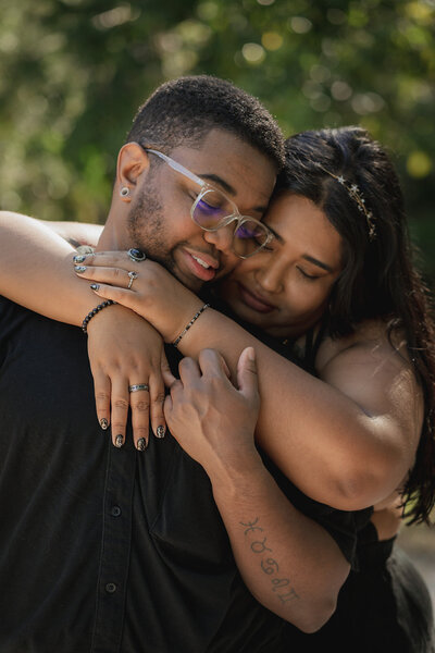 happy queer couple hugging during park engagement session