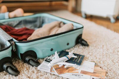 Open suitcase with international travel essentials – what I always pack for flying with kids