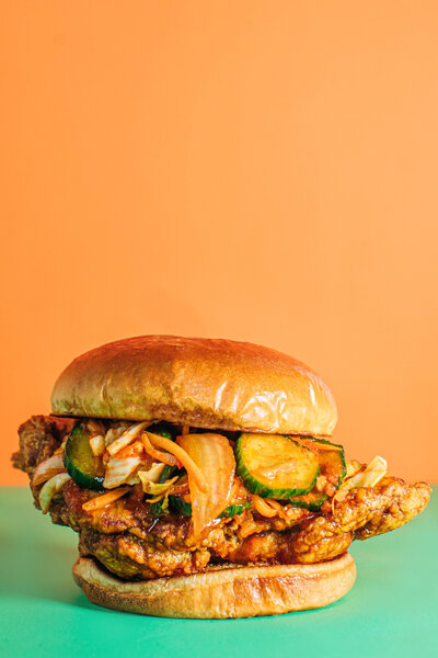 This client project for Good Day Cafe in Oxford, MS included a food styling shoot for their menu. White Studio photographed multiple sandwiches, including this The Ranch Hand fried chicken sandwich with pickles.