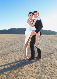 Sophia & Steve embracing standing in a dry lake bed