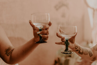 hands holding wine glasses