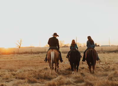Outdoor family photo session in Wyoming during golden hour, with a joyful family posed in a natural, scenic setting.