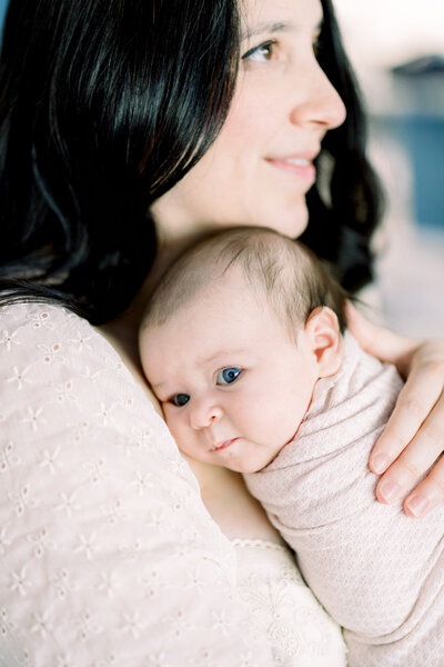 Close up portrait of baby on mom's chest taken by Tampa newborn photographer, Tina Marie Studio.