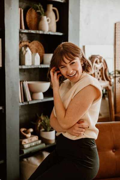 woman leaning on leather desk chair