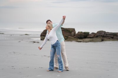 couple on wingersheek becah for engagement photos