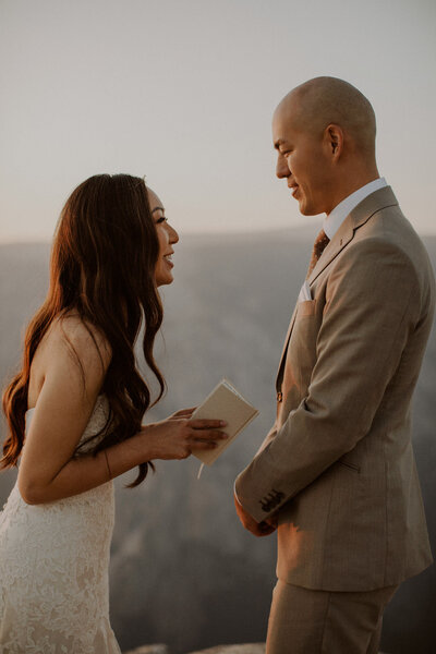 Bride and groom read vows in Yosemite