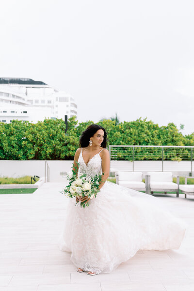 bride in white dress with white bridal bouquet