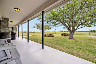 Back porch with view of the country side at this 3-bedroom, 2.5 bathroom rural vacation rental house just minutes outside of downtown Waco, TX.