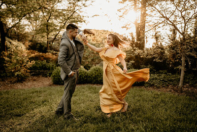 Engaged couple face  to face for engagement photos in golden hour sun on a beautiful fall evening at sunset