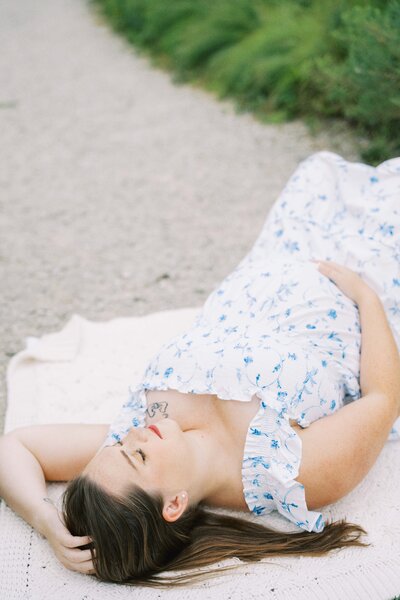 pregnant mom brushing her hair back during maternity photos