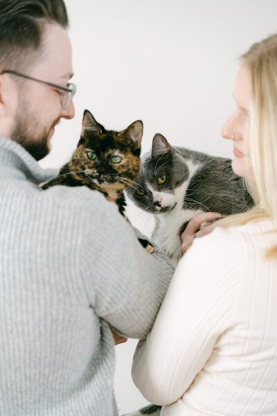 Couple with their cats during their in home portrait session