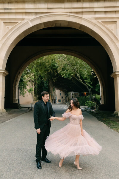 Couple posing for their engagement photo hugging with the Washington DC monument in the background.