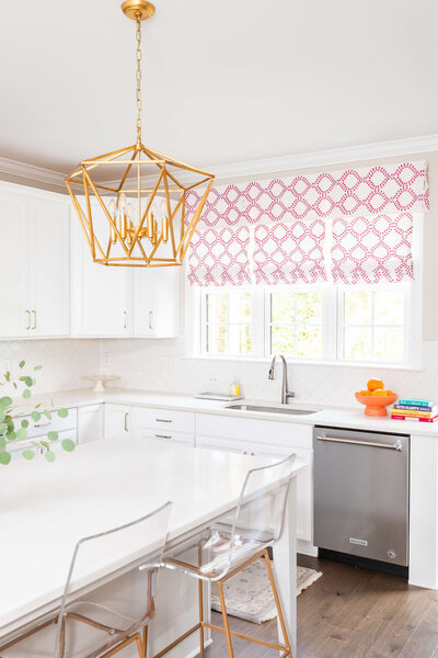 Bright kitchen with gold lighting fixture