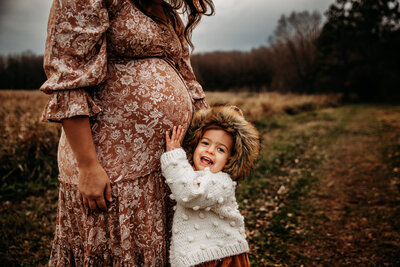 Couple holding baby belly