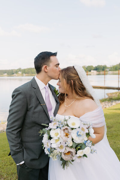 Bride and Groom sharing a kiss during their portraits at the lake in Ridgeway, SC.