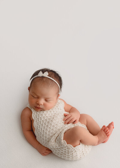 newborn photographer fort collins co posing brand new baby on white blanket