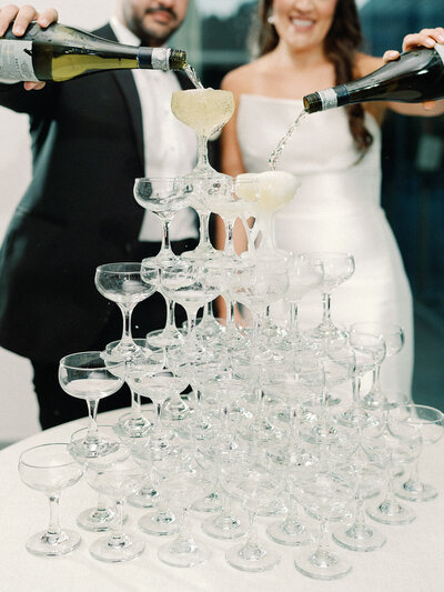 Bride and groom pouring a champagne tower