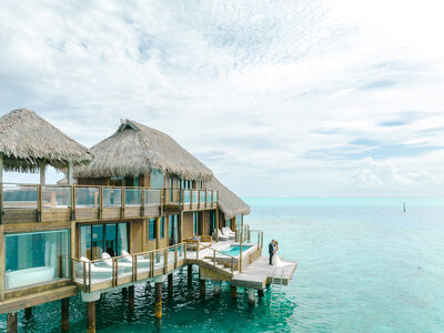 Aerial Drone view in the pacific islands, shades of blue, overwater bungalow in paradise