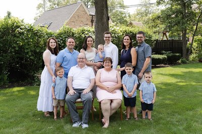 Extended family of twelve smiling, facing the camera in spring photo session in Chicagoland area