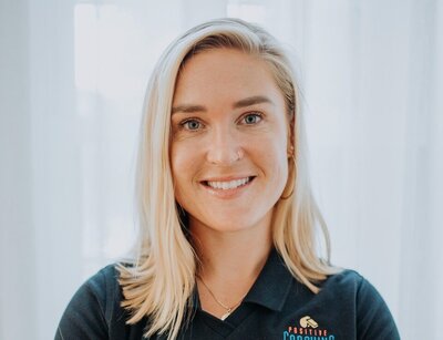 Headshot of Chloé in her uniform t-shirt for work in mental performance coaching