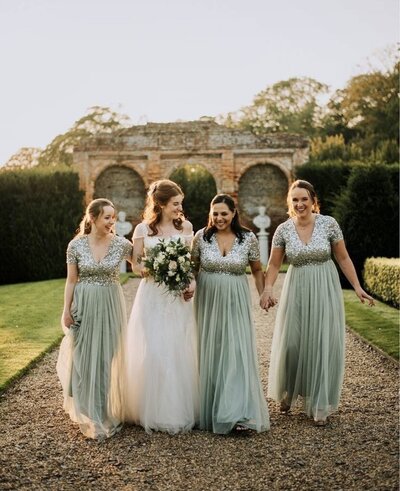 bridal party and bride wearing green dresses