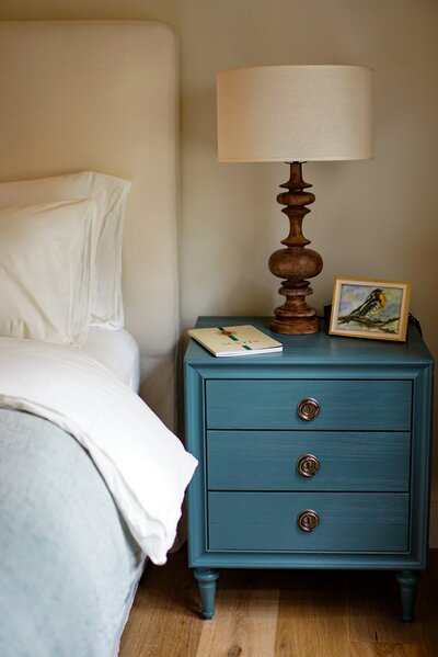 blue nightstand beside a bed
