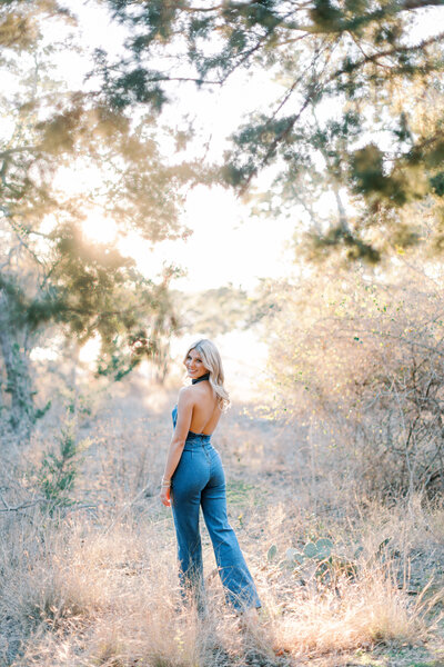 Portrait of high school girl in field with golden light by Malibu senior photographer