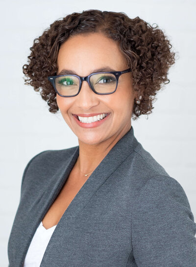classic studio headshot  wit subject smiling at camera