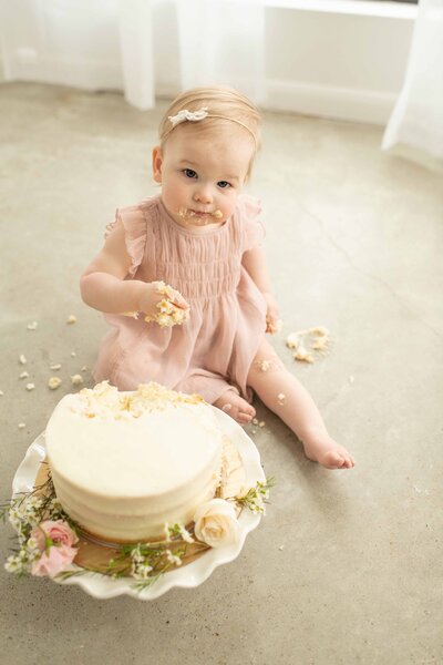 baby with smash cake for one year old birthday