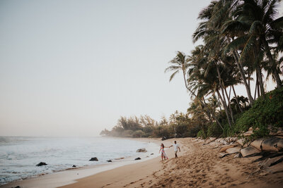 couple walking on beach in hawaii