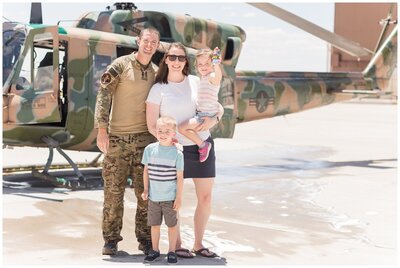 Family photo in front of an Air Force helicopter