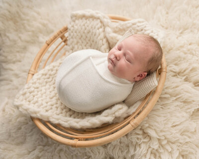 newborn baby in cream overalls in portalnd studio session