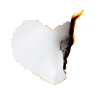 A heart shaped piece of white paper with the edge on fire with a visible flame