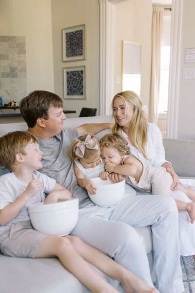 Virginia Family Photos | Family eating popcorn in their living room by light and airy fine art family photographer Jacqueline Aimee