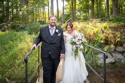 grooms holds brides face amongst flowers